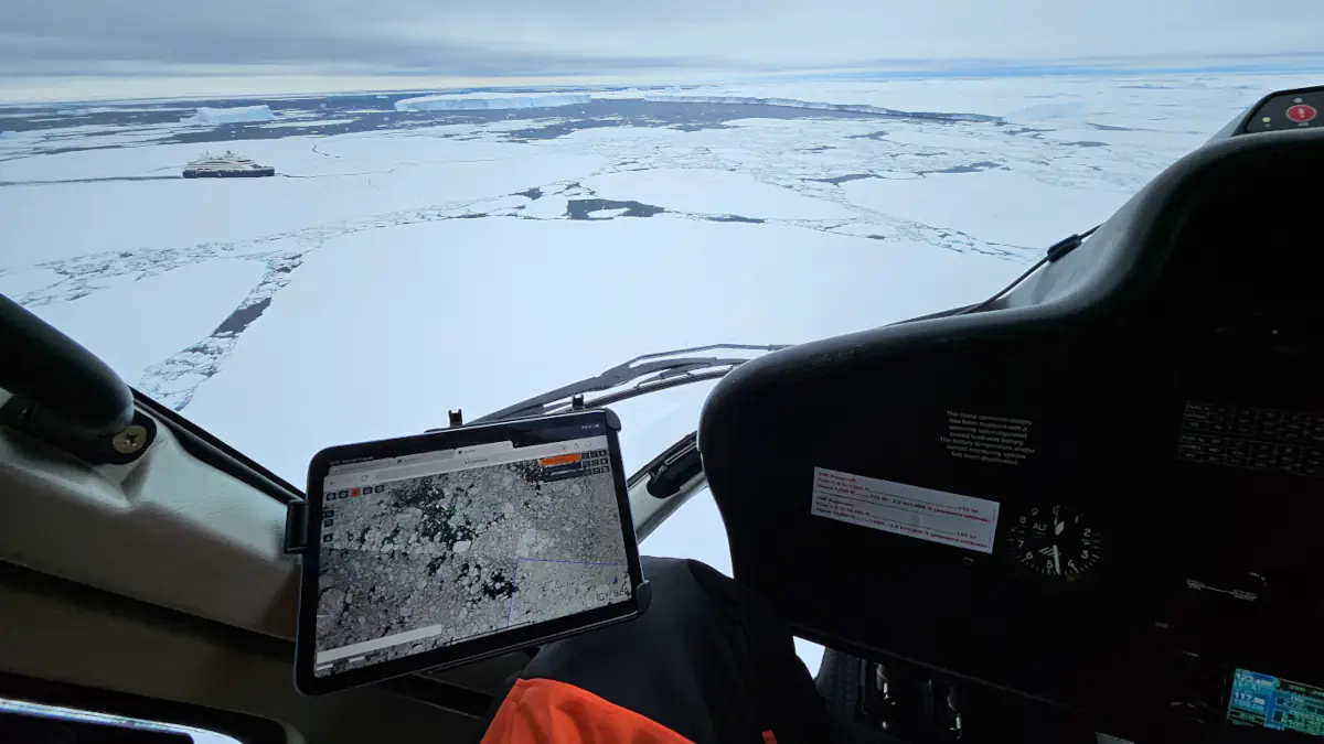 Helicopter view on icebreaking cruise ship 'Le Commandant Charcot'. Operator uses IcySea for airborne ice reconnaissance.